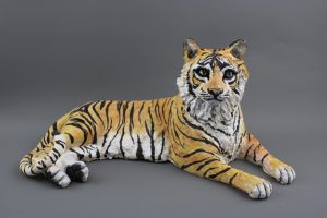sculpture of a tiger laying down