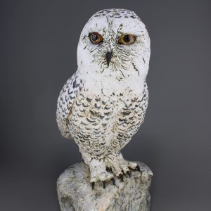 ceramic snowy owl sitting on a rock